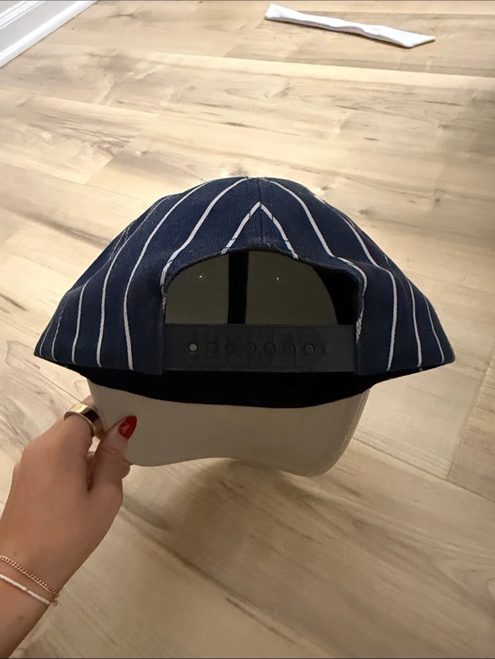 Hockey eyes without a face white and navy striped hat